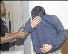  ?? NIR KEIDAR / AP ?? A 19-year-old dual U.S.-Israeli citizen covers his face outside a court in Rishon Lezion, Israel on Thursday. He is the prime suspect behind bomb threats against Jewish community centers in the United States.