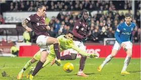  ??  ?? Jamie Walker slides the ball into an empty net to make it 4-1 to Hearts.