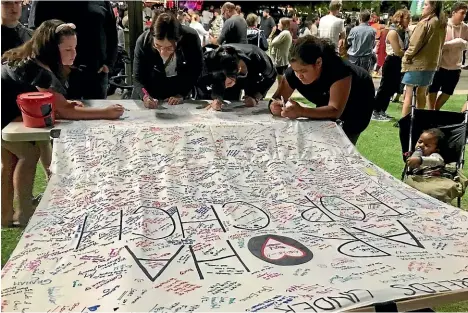  ??  ?? Manawatu¯ woman Shirvan Stewart made a large banner with ‘‘Aroha for Chch’’ and got people to sign it in the city on Saturday.