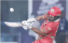  ?? — AFP ?? Oman’s captain Zeeshan Maqsood plays a shot during the ICC men’s Twenty20 World Cup cricket match between Oman and Scotland.