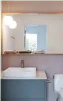  ??  ?? LEFT Peach-coloured ridged tiling from Ciot dresses the walls of this powder room, while repurposed quartz tops the vanity – a perfect match to the kitchen cabinetry. Pendant by Progress Lighting; Kohler sink; Hansgrohe faucet.