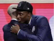  ?? FRANK FRANKLIN II/THE ASSOCIATED PRESS ?? Raptors pick OG Anunoby has his welcome-to-the-NBA moment with commission­er Adam Silver in Brooklyn.