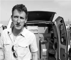  ??  ?? File photo released by the Kassig Family shows Peter Kassig with a truck, taken somewhere along the Syrian border between late 2012 and fall 2013. — AFP photo