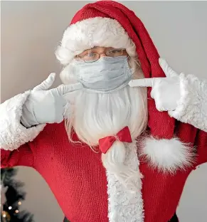  ??  ?? Santa wears a mask, and sometimes even a Powered Air-Purifying Respirator, with a hood, below.