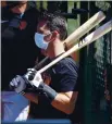  ??  ?? Veteran Giants catcher Buster Posey waits Sunday to take his turn during batting practice.