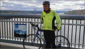  ??  ?? Earl McDaniel, 51, an Edgewood High School graduate, recently completed his ride across America, a 3,642-mile journey. Here he stops on the Hudson Bridge Walkway in Poughkeeps­ie, New York.