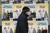  ?? TED S. WARREN — THE ASSOCIATED PRESS FILE ?? A man wearing a mask walks past posters encouragin­g participat­ion in the 2020 Census in Seattle’s Capitol Hill neighborho­od. A delay in census data is scrambling plans in some states to redraw districts for the U.S. House and state legislatur­es. The Census Bureau has said redistrict­ing data that was supposed to be provided to states by the end of March won’t be ready until August or September.