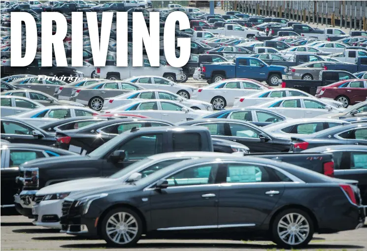  ?? — THE CANADIAN PRESS FILES ?? Vehicles are seen in a parking lot at the General Motors Oshawa assembly plant in Oshawa, Ont., last year.