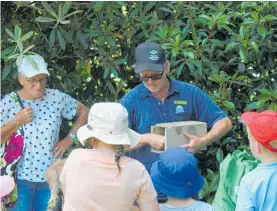  ?? Photo / Alyssa Smith ?? Taranaki Regional Council environmen­t officer Chauncy Ardell displays different pest traps at a school holiday activity.