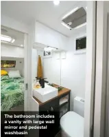  ??  ?? The bathroom includes a vanity with large wall mirror and pedestal washbasin