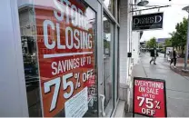  ?? Steven Senne / Associated Press ?? This was the scene passersby encountere­d in Dedham, Mass., early in September — signs noting that a store was closing in the midst of the pandemic.