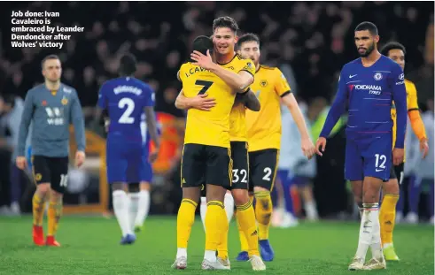  ??  ?? Job done: Ivan Cavaleiro is embraced by Leander Dendoncker after Wolves’ victory