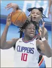  ?? SUE OGROCKI – THE ASSOCIATED PRESS ?? Thunder forward Josh Hall, rear, defends Clippers center Daniel Oturu during Sunday night’s game.