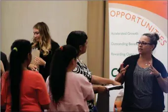  ?? MARCIO JOSE SANCHEZ ?? In this Thursday photo, Kathy Tringali, right, a recruiter for retailer Big 5 Sporting Goods, talks to job seekers during a job fair in San Jose. On Friday the U.S. government issued the August jobs report.