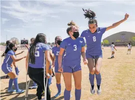  ??  ?? Cameren Gantt, left, and Gabrielle Farrar celebrate beating Socorro on Thursday in Albuquerqu­e for a state soccer title. Socorro did manage to score in the 72nd minute, snapping a Lady Horsemen scoreless streak that extended from the season opener in March.