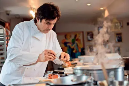  ??  ?? Jean-christophe Novelli putting the finishing touches on his dish