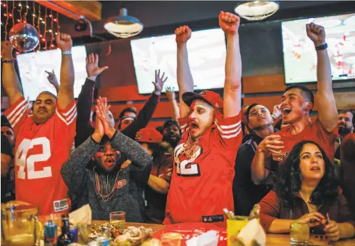  ?? Gabrielle Lurie / The Chronicle ?? (From left) 49ers fans Raul Rodriguez, Lou Johnson and Gary Heimeyer cheer at Hi Tops bar as the 49ers notch a firsthalf touchdown.