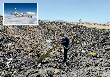  ?? AP ?? The CEO of Ethiopian Airlines, Tewolde Gebremaria­m, looks at the wreckage of the Boeing 737 Max 8 that crashed shortly after takeoff from Addis Ababa, Ethiopia, yesterday, killing all 157 people thought to be on board.