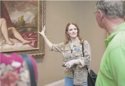  ?? ASHLEE REZIN/ SUN- TIMES ?? Ali Kemp, 30, of Downers Grove, a Renegade Tour Guide at Museum Hack, gestures toward Titian’s painting “Danae and the Shower of Gold” during an Un- Highlights Tour at The Art Institute of Chicago on Monday.