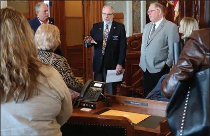  ?? ?? Kansas state Rep. Will Carpenter, a Republican, speaks to young adults with intellectu­al disabiliti­es and their parents about a proposal to shrink waiting lists for services, as House Speaker Dan Hawkins, right, also a Republican, listens Feb. 12 in the House chamber at the Statehouse in Topeka, Kan. Carpenter is the architect of the proposal to boost spending by $46 million so that 1,000 of the 7,500 people on state waiting lists come off those lists.