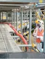  ?? AFP ?? Workers open valves as they pour coolant to freeze the ice wall around the Fukushima Daiichi nuclear power plants in Okuma. —