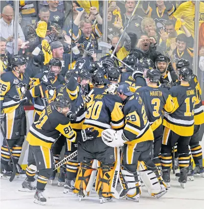  ??  ?? The Penguins celebrate after beating the Senators in Game Seven of the Eastern Conference finals.