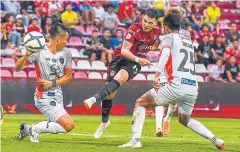  ??  ?? Muang Thong’s Tristan Do, centre, attempts a shot against Nakhon Ratchasima.