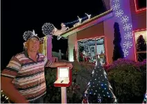  ??  ?? Graham Holdaway spent five days putting up 16,000 lights at his Stoke home.