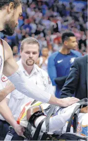  ?? [PHOTO BY SARAH PHIPPS, THE OKLAHOMAN] ?? Oklahoma City’s Steven Adams checks on Nerlens Noel as he is taken off the court during Tuesday’s game with the Minnesota Timberwolv­es at the Chesapeake Energy Arena.