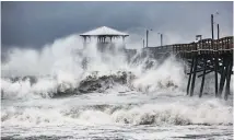  ??  ?? Hurricane Florence whipped up large waves and caused flooding in coastal areas in North Carolina ahead of making landfall.