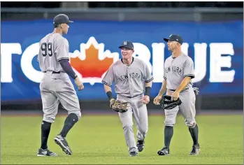  ?? Corey Sipkin ?? A HOLE TO FILL: Aaron Judge, celebratin­g Friday’s victory in Toronto with outfielder­s Billy McKinney (center) and Brett Gardner, could see time in center field this series with Aaron Hicks being forced to the disabled list because of an intercosta­l...