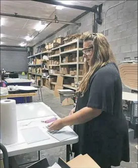  ??  ?? Glass artist Meeghan Triggs separates strips of glass to make her Mother Nature's Nesting Bowls in her Turtle Creek studio.