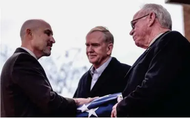  ?? (Photo by Logan Kirkland, SDN) ?? From left: Interim Director of the G.V. “Sonny” Montgomery Center for America’s Veterans Brian Locke presents a retired flag to both Tim Thames and Jerry Thames, sons of Colonel John Ware Thames, who was honored and remembered at a ceremony held on...