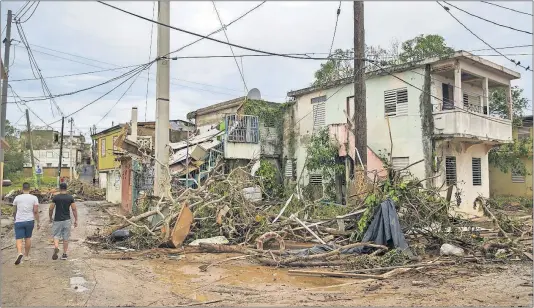  ?? [VICTOR J. BLUE/THE NEW YORK TIMES PHOTOS] ?? Debris from Hurricane Maria remained piled up in Arecibo, Puerto Rico, on Sept. 23. The storm devastated the Caribbean island of 3.4 million people, but the early response on the U.S. mainland was muted, even though the island is a U.S. commonweal­th.