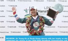  ??  ?? INCHEON: Jin Young Ko of South Korea dances with her trophy as she celebrates her victory of the LPGA KEB HanaBank Championsh­ip golf tournament. —AP