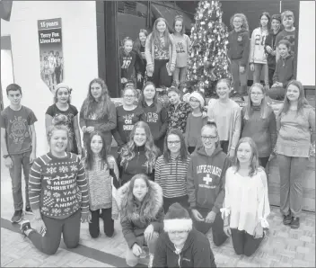  ?? KIRK STARRATT ?? Evangeline Middle School students gather around the Tree of Hope just prior to a special assembly on Dec. 21 where money raised and gifts donated through the initiative were presented to representa­tives of Chrysalis House and the Kids Action Program.