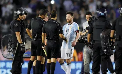  ??  ?? BUENOS AIRES: Argentina’s forward Lionel Messi (2nd-R) argues with second assistant referee Marcelo Vangasse (2nd-L) next to Brazilian referee Sandro Ricci (L) and first assistant referee Emerson Augusto de Carvalho (R) in the half time of their 2018 FIFA World Cup Russia South American qualifier football match against Chile, at the Monumental stadium in Buenos Aires, on March 23. FIFA yesterday suspended Messi for four Argentina games. — AFP