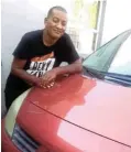  ?? ?? Geret Carolus, 48, poses with the car his mother Magrietta says is now the only reminder she has of him since his death in a shooting at a Cape Town hospital.