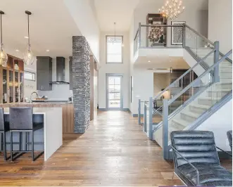  ??  ?? The view from the back of the main floor of the Kimber home shows just how open and light the space feels thanks to the elevated ceilings.