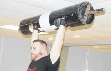  ?? LYNN CURWIN/TRURO NEWS ?? Dillon Fraser lifts a 185-pound log bar. The Truro man works out at the gym about five days a week to prepare for strongman competitio­n.