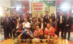  ??  ?? PRIZE PRESENTATI­ON ... Terrance (seated centre) and Philip (seated 2nd right) with organising committee pose with the medallists for one of the categories contested on the final day of the National Invitation­al Weightlift­ing Championsh­ip here yesterday.