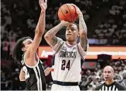  ?? Jessica Hill/Associated Press ?? UConn’s Jordan Hawkins shoots as Providence’s Devin Carter defends during the second half on Wednesday in Storrs.