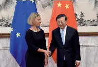  ?? — AFP ?? Federica Mogherini greets Yang Jiechi in Beijing on Wednesday.