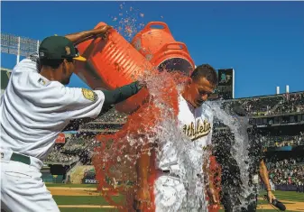  ?? Jason O. Watson / Getty Images ?? Matt Chapman, doused after a game-ending single against the Giants this month, has provided stellar defense in addition to his .846 OPS, which ranks third among AL third basemen.