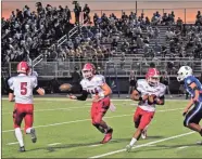  ?? Frank Crowe ?? Junior quarterbac­k Brady Lackey exchanges the football with freshman Brant Bryant during the Phoenix’s game against the Ringgold Tigers at Ringgold High School on Oct. 4.