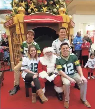  ?? JOHN FAUBER / MILWAUKEE JOURNAL SENTINEL ?? The Mielke children (clockwise, from lower left), Marina, Eric, Austin and Alex, pose with Santa at Brookfield Square mall, continuing a family tradition of shopping on Christmas Eve.