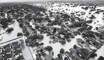  ?? DAVID J. PHILLIP/AP ?? Residentia­l streets east of downtown Houston are filled with muddy water following Tropical Storm Harvey in August.