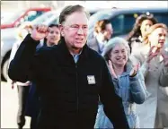  ?? Tyler Sizemore/Hearst Connecticu­t Media ?? Gov. Ned Lamont campaigns with fellow Democrats outside the District 7 polling center at Greenwich High School in Greenwich on Election Day, TuesdayA new report pushes the projected state surplus to almost $2.8 billion, and suggests state finances are well prepared through 2025.