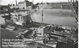  ??  ?? A group of workers load tiles onto a boat at Bridgwater docks for export c1950