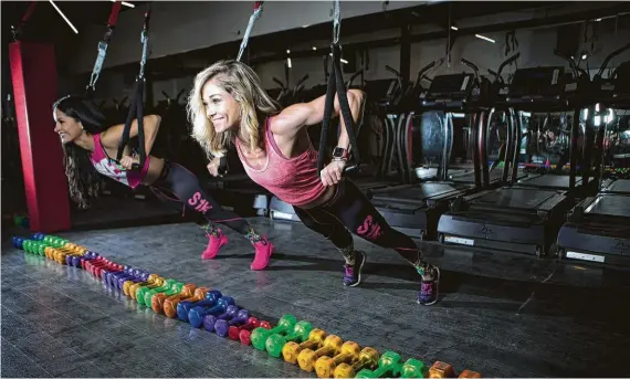  ?? Marie D. De Jesús / Houston Chronicle ?? Ana Barron, left, and Natasha Smith, right, work up a sweat at SWEAT 1000.